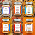 Collection of Cardoza Legacy spice jars on a textured orange background