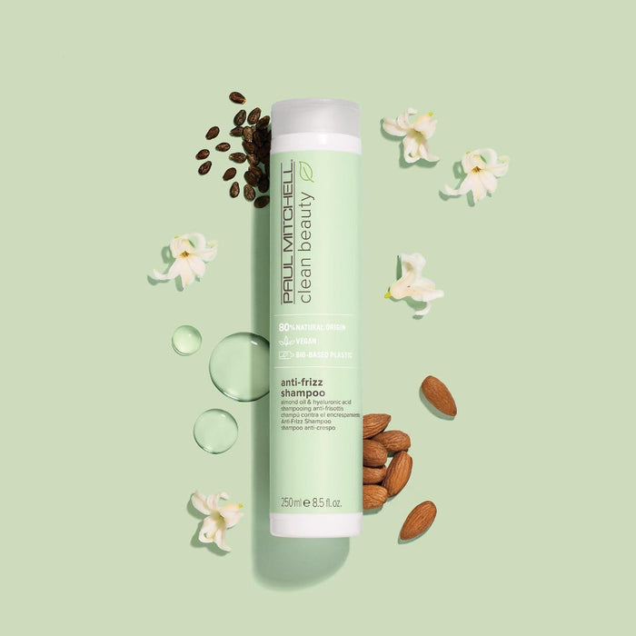 Artistic image of Clean Beauty Anti-Frizz Shampoo with the ingredients surrounding the bottle on a soft green background
