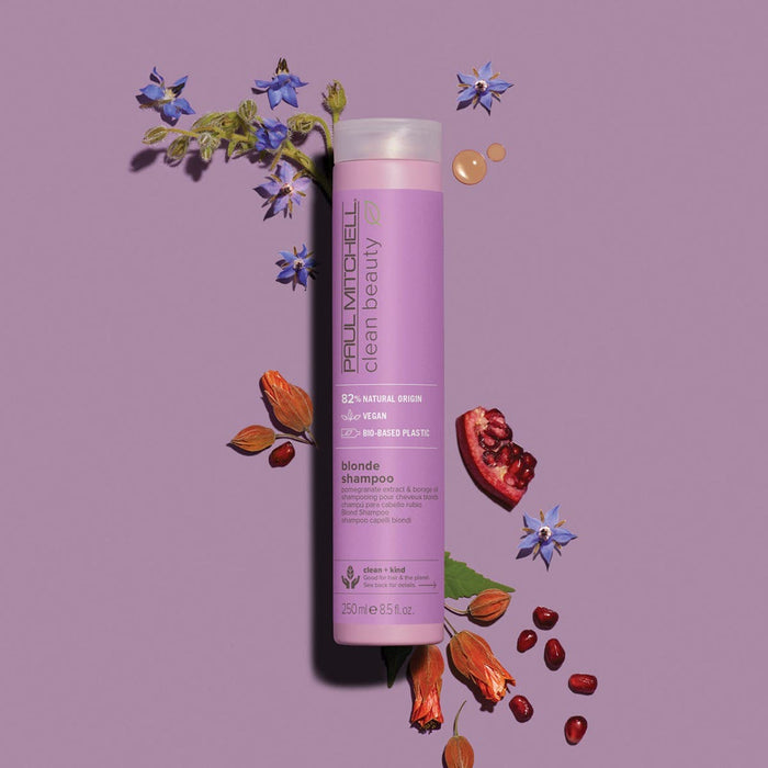 Clean Beauty Blonde Purple Shampoo artistic image with ingredients around the bottle on a light pink & purple background