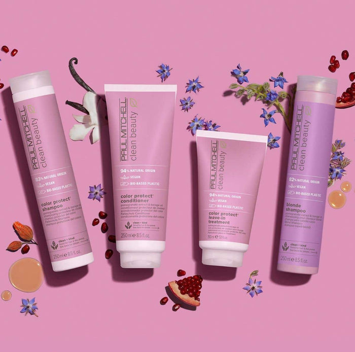 Clean Beauty Color Protect Collection artistic image with ingrendients around the bottles on a light pink & purple background