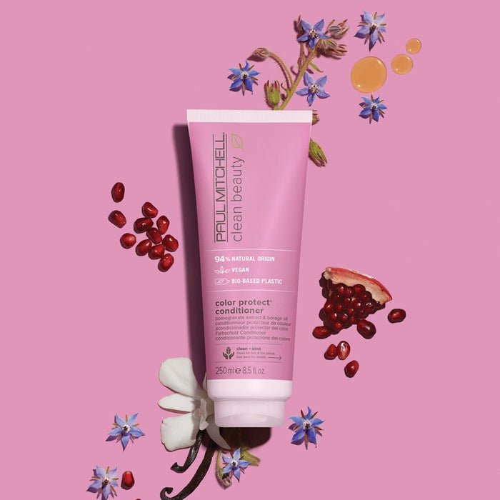 Clean Beauty Color Protect Conditioner artistic image with ingredients surrounding the tube on a light pink background