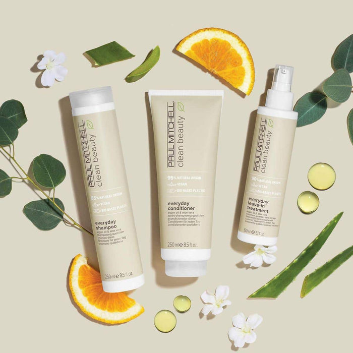 Artistic image of Clean Beauty Everyday Collection with ingredients around the bottles