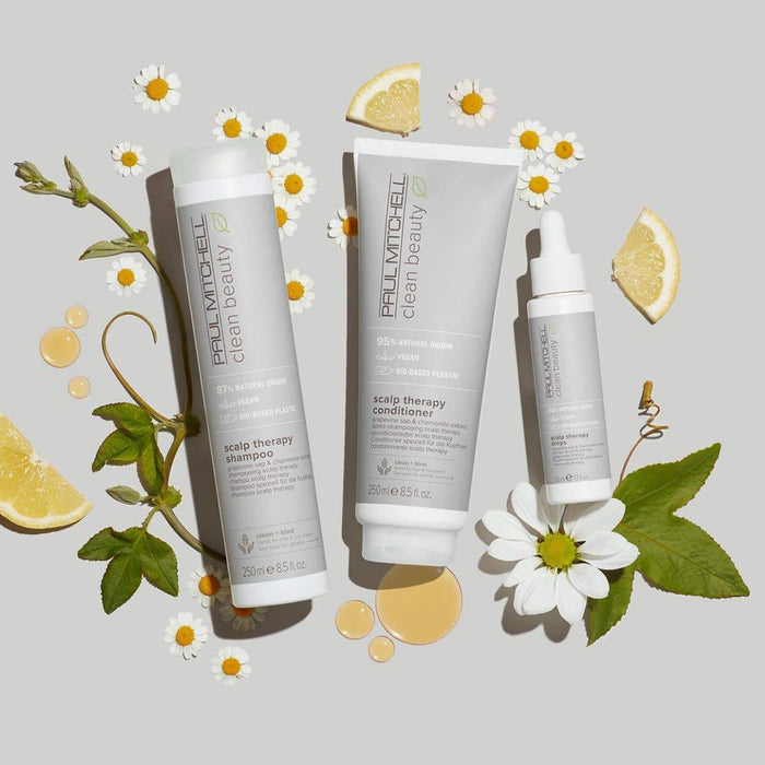 Clean Beauty Scalp Therapy Collection artistic image with ingredients surrounding the bottles