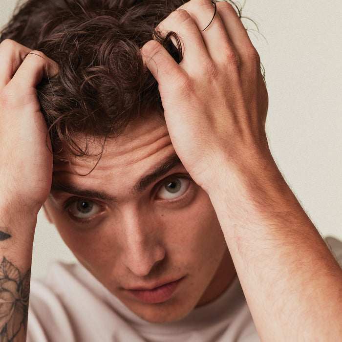 image of a man running his fingers through his hair