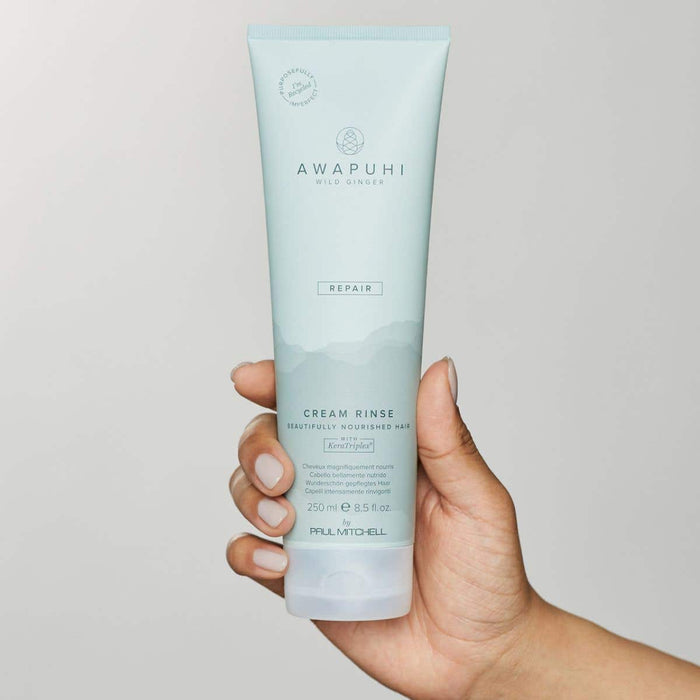 Image of someone holding a tube of Cream Rinse on a neutral background