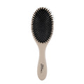 The Dressing Brush is designed to smooth styles and distribute scalp oils to enhance natural shine.