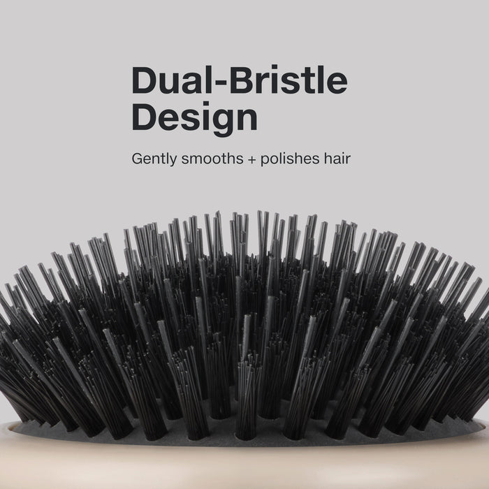 The Dressing Brush features a dual-bristle design to gently smooth and polish hair.