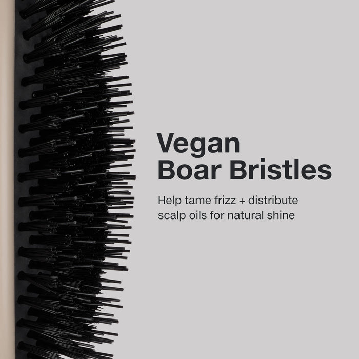 The Dressing Brush has vegan boar bristles to help tame frizz and distribute scalp oils for natural shine.