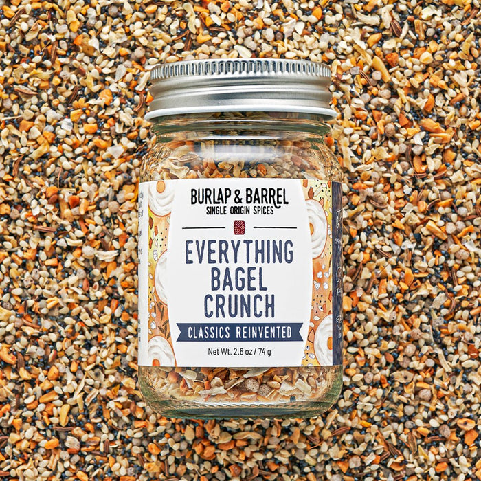 Jar of 'Everything Bagel Crunch' seasoning mix on a textured surface
