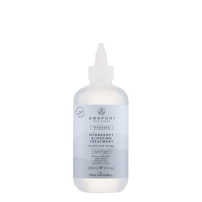 A white bottle with a pump dispenser labeled HydraSoft Glossing Treatment from Awapuhi Wild Ginger.