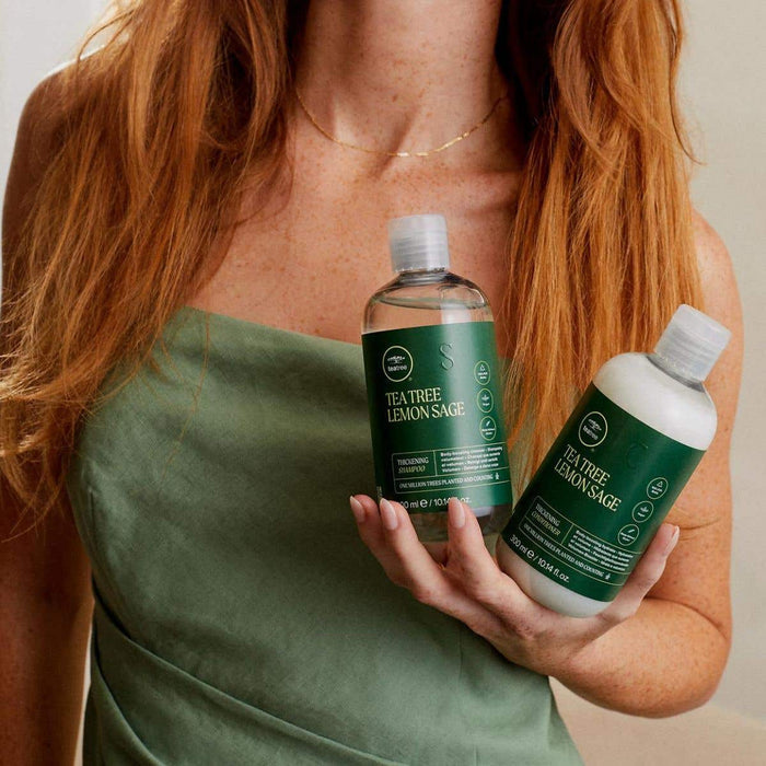 Tea Tree Lemon Sage Thickening Shampoo & Conditioner in hand
