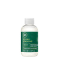 A bottle of Tea Tree Lemon Sage Thickening Shampoo on a white background