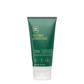 A tube of Tea Tree Lemon Sage Thickening Treatment hair mask on a white background