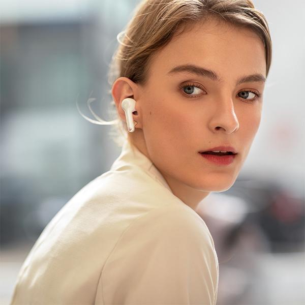 soundcore white earbud worn for wireless listening