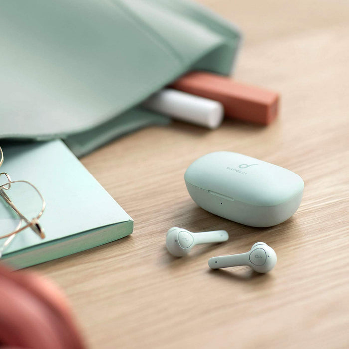soundcore wireless earbuds with charging case on desk
