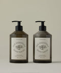Two bottles of Oak Essentials Jenni Kayne hand care products on a beige background