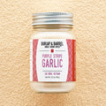 Jar of Purple Stripe Garlic from Burlap & Barrel on a beige background