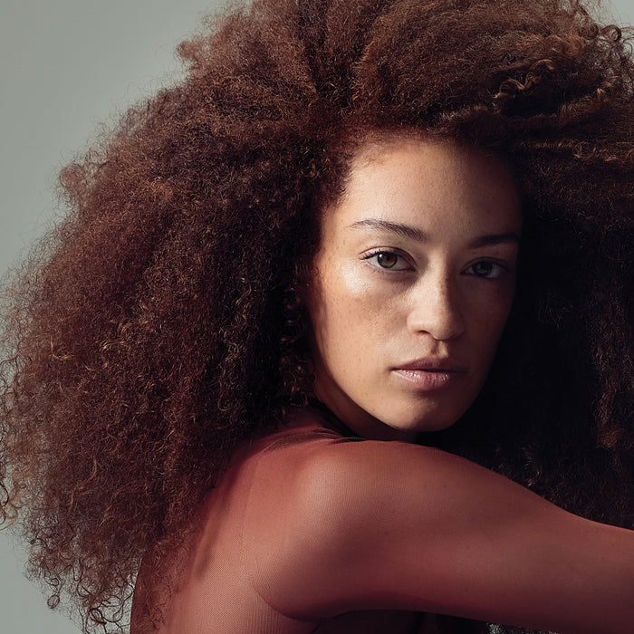 image of a woman with voluminous, coily, brunette hair