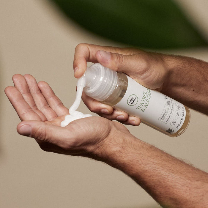 Tea  Tree Scalp Care Regeniplex Root Lift Foam being dispensed into hand