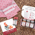 Spice set with jars, a towel, and recipe cards on a textured surface