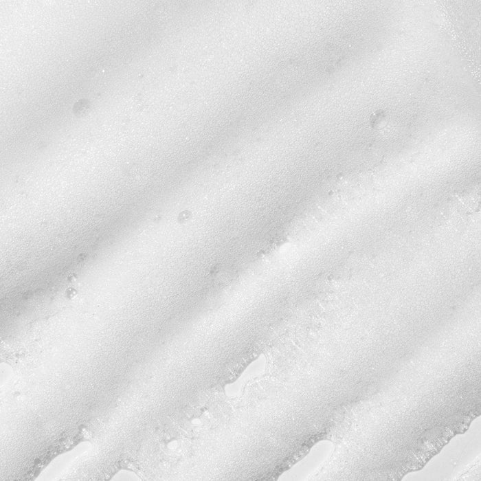 Close-up texture smear of Paul Mitchell Pet Soothing Oatmeal No Rinse Shampoo