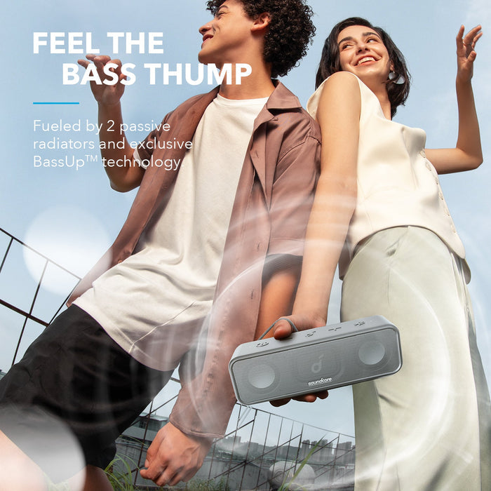 soundcore BassUp bluetooth speaker with two people outdoors