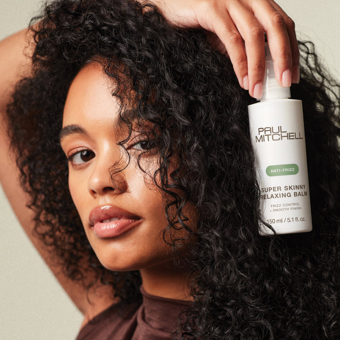 Model holding Super Skinny Relaxing Balm
