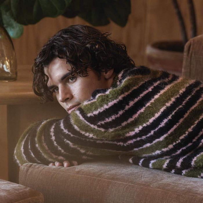 Tea Tree male model wit ha finished look in a lifestyle setiing
