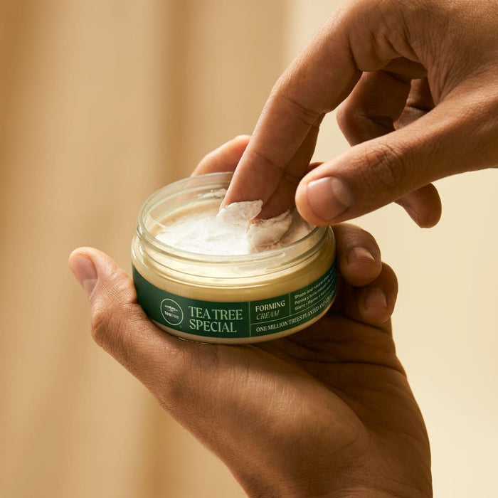 Male taking swab of Tea Tree Special Forming Cream out of the jar