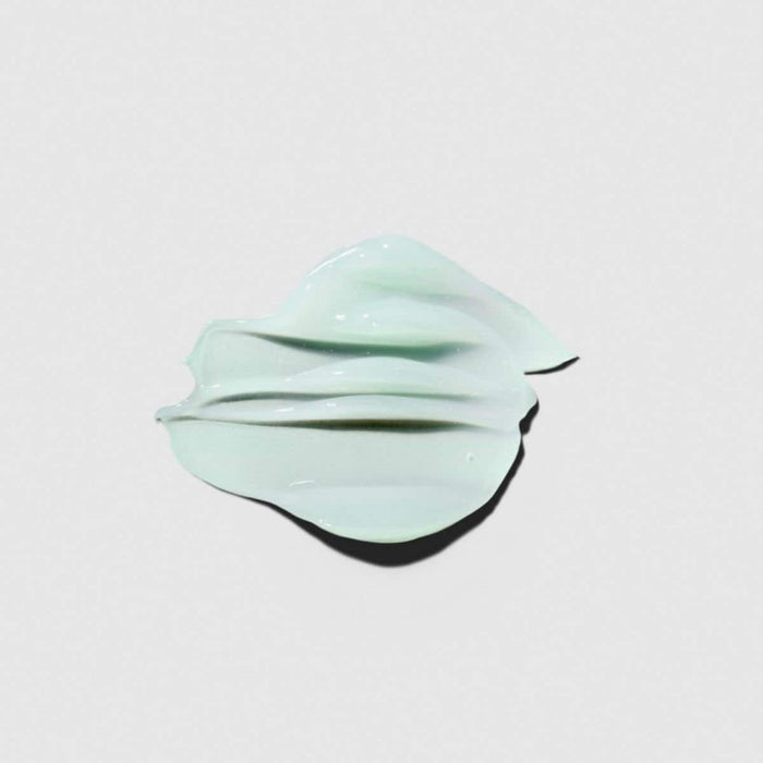 Tea Tree Special Hair and Body Moisturizer texture smear on a neutral background