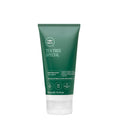 A tube of Tea Tree Hair and Scalp Treatment on a white background