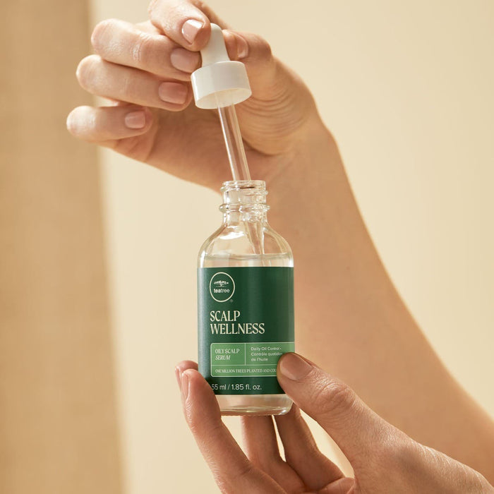 Tea Tree Scalp Wellness Oily Scalp Serum close-up of model dispensing contents.