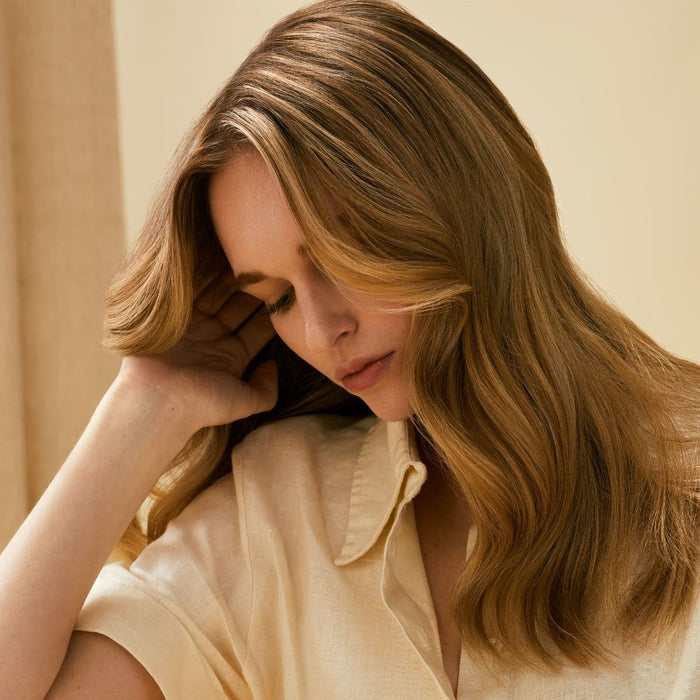 Tea Tree Scalp Wellness female model holding her hair / head
