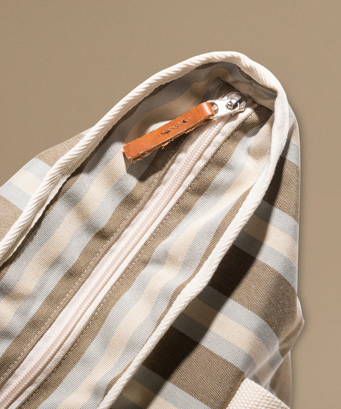 Beach bag with stripes against a beige background