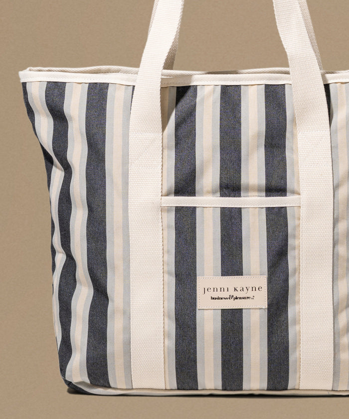 Striped tote bag with 'jenni kayne' label on a beige background