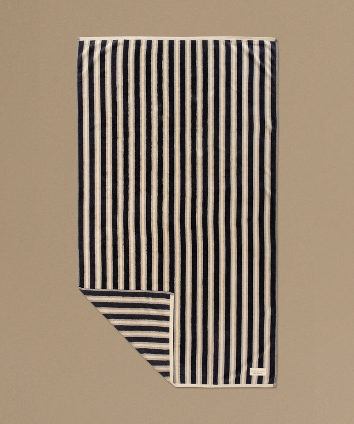 Striped fabric with black and white stripes on a beige background