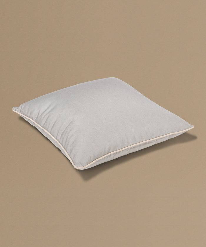 Light gray pillow on a beige background