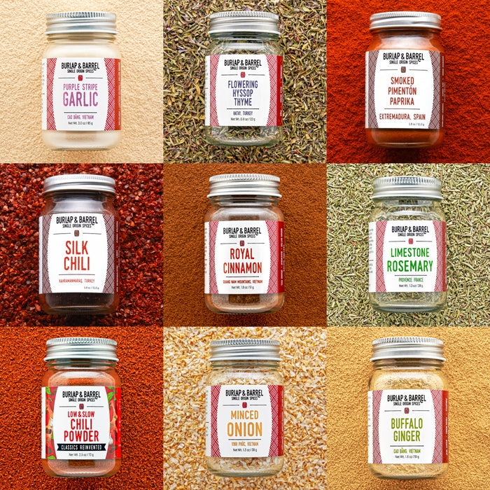 Grid of Burlap & Barrel spice jars with labels on a textured background