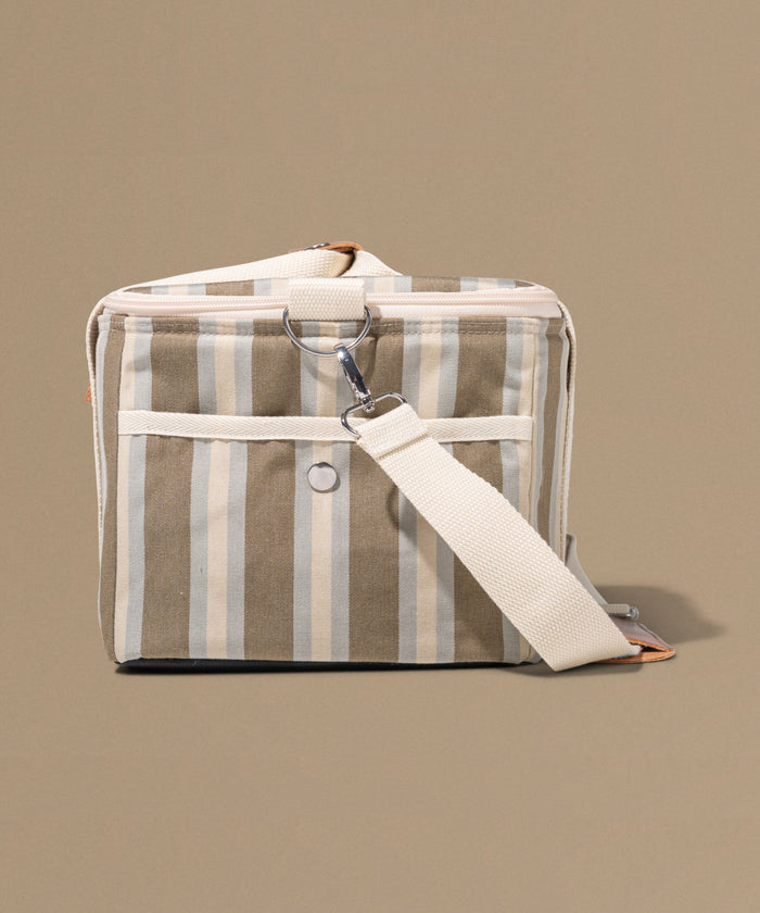 Striped fabric bag with a strap on a beige background