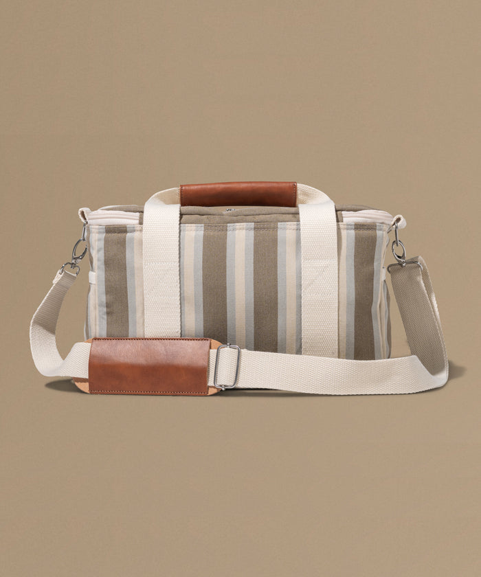 Striped bag with brown accents on a beige background