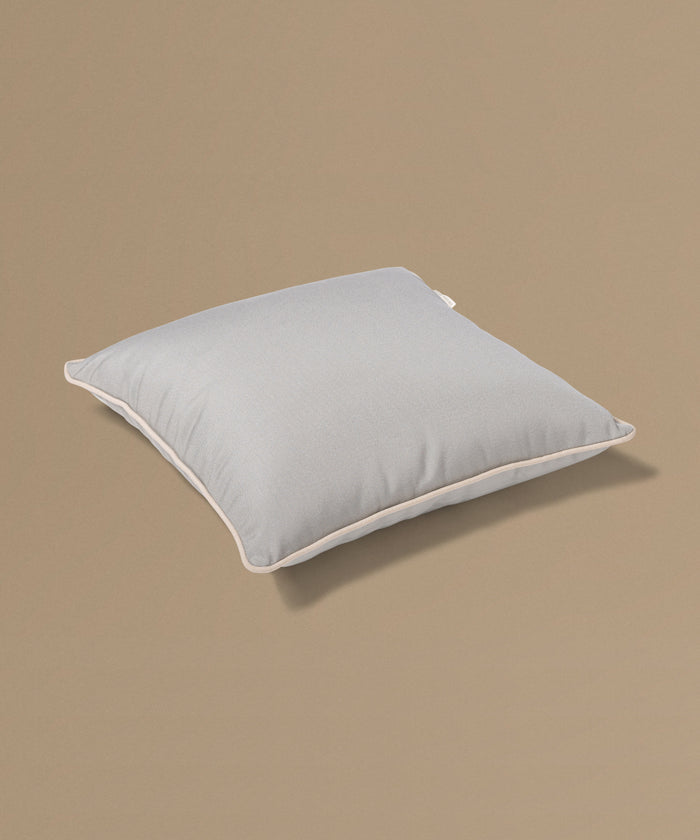 Light gray pillow on a beige background