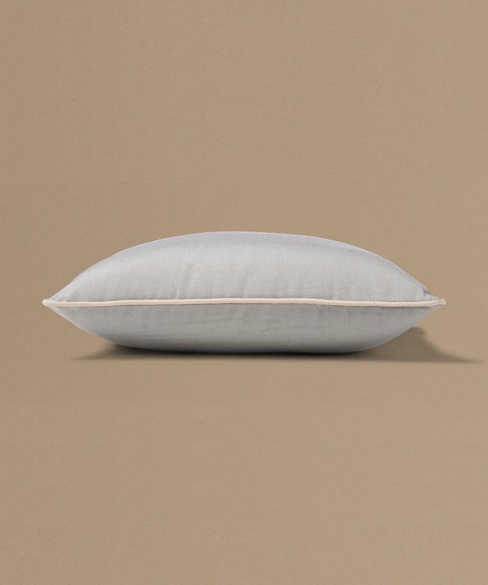 Light gray pillow on a beige background